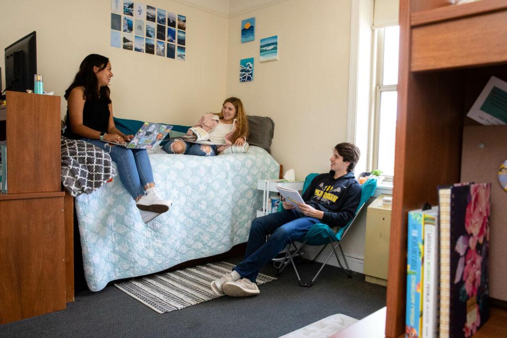 Students hang out in a residence hall room.